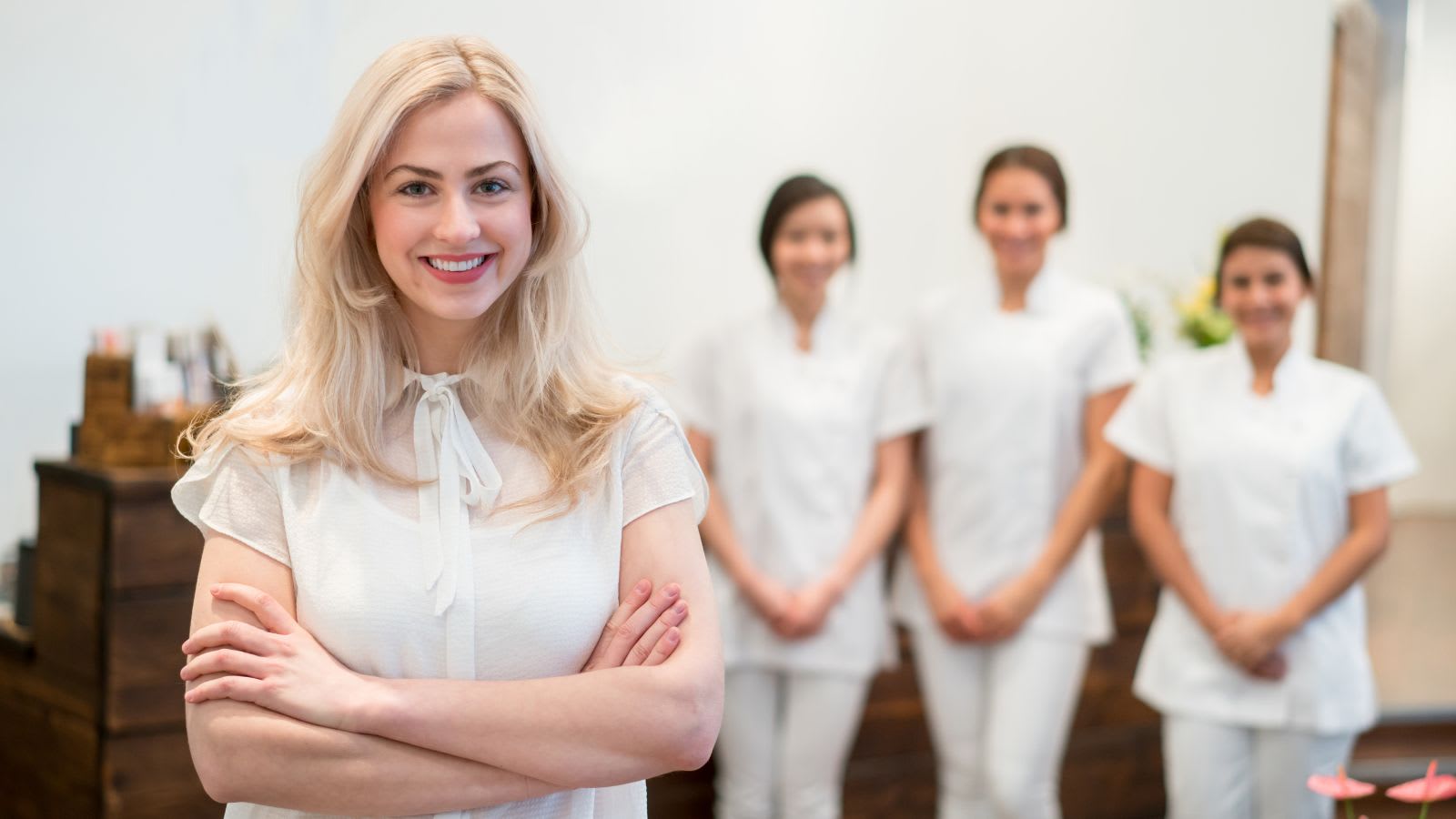 photo of med spa owner with staff in background